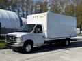 A white 2019 Ford Econoline box truck with a blank cargo area and a flatbed chassis parked on a street