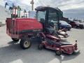 A red 2014 Toro Groundmaster 5910 turf maintenance machine with a covered cab and dual front mowers attached