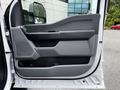 Interior view of the driver's side door of a 2024 Ford F-550 featuring a gray panel design with a handle and storage compartment