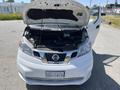 A 2019 Nissan NV200 with its hood raised revealing the engine compartment