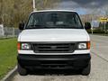 A 2004 Ford Econoline van facing forward with a white exterior and black front bumper