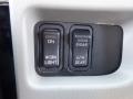 A dashboard control panel featuring two buttons labeled Work Light and Disab along with a sixth gear indicator