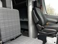 A 2016 Mercedes-Benz Sprinter van interior featuring two seats one with a gray checkered pattern and a driver's seat with armrest and ergonomic design