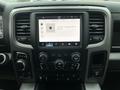 The interior dashboard of a 2022 RAM 1500 Classic featuring a large touchscreen display with media controls and buttons for drive modes