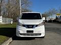 A white 2017 Nissan NV200 van viewed from the front with a prominent grille and headlights.