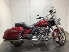 2016 Harley-Davidson FLHR motorcycle with a deep red finish chrome accents and a large windshield