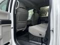 Interior view of a 2021 Ford F-550 showing the backseat area with gray fabric seats and floor mats