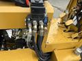 Hydraulic connections and control valves on a yellow 2024 AGT Industrial KRW23 Mini Loader
