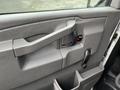 Interior door panel of a 2017 Chevrolet Express featuring a door handle window crank and storage pocket