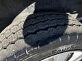 Close-up of a tire from a 2017 Nissan NV200 showing tread patterns and some dirt on the surface