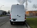 A 2022 Mercedes-Benz Sprinter van viewed from the rear with a white exterior and a simple design