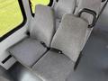 Two gray upholstered seats with seat belts inside a 2010 Ford Econoline van