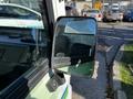 Close-up of the driver side mirror of a 2019 CanEV Might-E Truck showing its reflective surface and mounting bracket