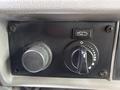 Control panel of a 2013 Kenworth T370 featuring a round knob for adjusting settings and a dial with indicators for wiper functions
