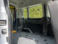 Interior view of a 2022 Ford Transit van showing empty cargo space with a flat floor and side paneling