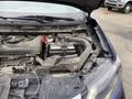 A 2019 Nissan Rogue with an open hood showcasing the engine compartment and battery area