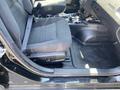 Interior view of a 2019 Dodge Charger showing the driver's seat with fabric upholstery and a floor mat