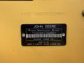 A 2013 John Deere 710K backhoe loader identification plate displaying the product identification number and manufacturing details