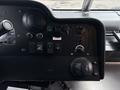 Dashboard of a 2018 Ford Econoline showing various controls and gauges including knobs and switches