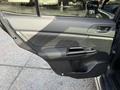 Interior view of a 2021 Subaru WRX car door with a sleek design and power window controls visible