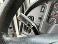 Close-up of the gear shift and control panel inside a 2016 Freightliner 108SD showing various buttons and switches