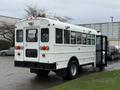 2016 International CE300 school bus with a white exterior and multiple windows parked with its door open