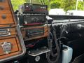 The control panel of a 1991 Sutphen Deluge featuring radios switches and a microphone with a black coiled cord
