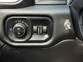 Interior dashboard controls of a 2020 Ram 2500 featuring knobs for headlight settings and an additional toggle switch