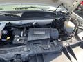 The engine compartment of a 2012 Chevrolet Express showcasing various components including the air filter housing battery and coolant reservoir