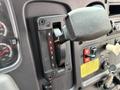 Close-up of a gear shift lever with the positions R N D 3 2 L clearly labeled on a 2014 Freightliner B2 dashboard