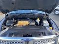 A 2017 RAM 1500 engine compartment with a visible engine block various components and a coolant reservoir