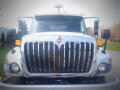 A 2016 International WorkStar 7500 truck with a chrome grille and multiple orange lights on the roof facing forward
