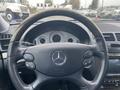 Interior view of a 2007 Mercedes-Benz E-Class dashboard featuring a steering wheel with controls and the vehicle's speedometer and tachometer in the background