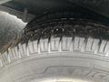 A close-up view of a tire from a 2018 Chevrolet Express showing tread patterns and water droplets on the surface