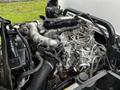 Engine of a 2019 Hino 195 showing detailed components including pipes wires and a large metallic structure