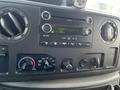 Dashboard of a 2009 Ford Econoline featuring a radio display with FM settings and control knobs for temperature and air conditioning
