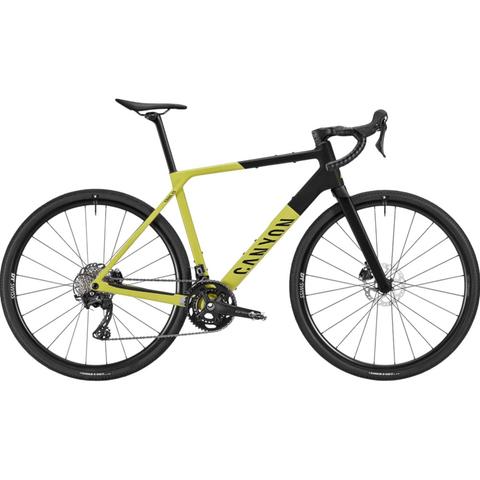 2026 Canyon Grail CF 7 Carbon Gravel Road Bike with a yellow and black frame featuring drop handlebars disc brakes and wide tires designed for gravel terrain