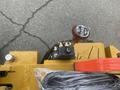 A close-up view of the joystick control of a 2024 AGT KRW 23 Mini loader with various levers and switches visible