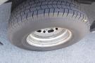 A close-up view of a tire mounted on a rim designed for a 2012 Mercedes-Benz Sprinter with a tread pattern visible on the rubber