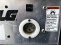 Close-up of a 2000 JLG 12SP electrical outlet with a warning label about explosion and fire hazards and a circuit switch labeled 3 AMP