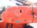 2008 JLG Boom Lift 400S model with an orange body visible in the foreground featuring safety symbols and numerical markings