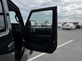 A 2019 Jeep Wrangler with its driver's door open showing the interior and a side mirror