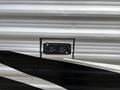Close-up of a black electrical outlet cover on the side of a 2021 Jayco Jay Flight travel trailer