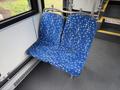 Two blue fabric seats with a modern geometric pattern in a 2018 Grande West Vicinity bus interior