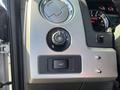 Interior controls of a 2014 Ford F-150 including a dial for lights and a switch for fog lights
