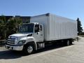 A white 2020 Hino 268 box truck with a large cargo area and front cab featuring chrome accents and a Toyota logo