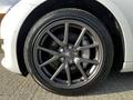 A close-up of a 2019 Tesla Model 3 wheel showcasing a sleek multi-spoke alloy rim and a tire with prominent tread patterns
