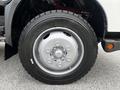 Close-up of a gray wheel on a 2014 Hino 195 vehicle featuring a silver rim and a black Michelin tire with visible tread patterns
