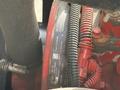 Close-up view of a 2016 Freightliner 108SD engine showing hoses and electrical connections in red and black colors