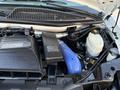 The engine compartment of a 2015 GMC Savana displaying the diesel engine components including the air intake and various fluid reservoirs